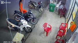 Motorcycles topple after person leans on one in Sóc Trăng, Vietnam