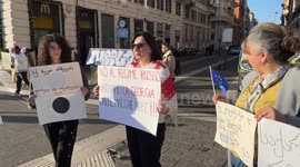 Women of Georgian origin hold signs protesting the results of the Georgian elections in an impromptu sit-in in Rome.