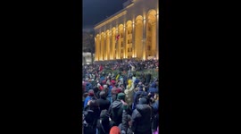 Protesters rally with flashlights and chant in unison in Tbilisi, Georgia