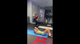 Friend slams stick to keep girl moving during exercise routine