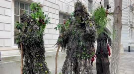Walking trees and Christmas jumpers outside the Department for Energy in London as activists stage protest against Drax