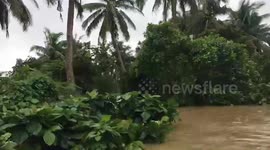 Rescue volunteers evacuate residents from flooded town in the Philippines
