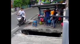 Motorbike falls into water-filled pit in Jakarta, Indonesia