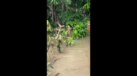 Residents wade through waist-deep flood in the Philippines