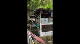 Worker grabs colleague's neck while sliding down zip line