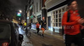 Christmas runners run through Soho Square in London's West End