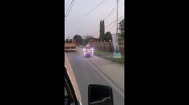 Santa Claus cruises along road on illuminated motorcycle