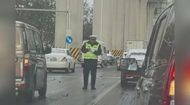 China: Traffic Cop Nearly Slips While Braving Ice to Push Cars After Snowstorm