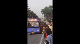 Kind locals help to push broken down bus stuck on slope in Thailand