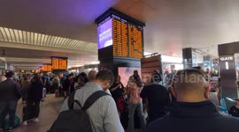 Travelers stopped at the Rome Termini station waiting to be able to catch a train while the boards signal severe delays in train departures and arrivals due to a technical fault at the Termini and Tiburtina railway stations in Rome.