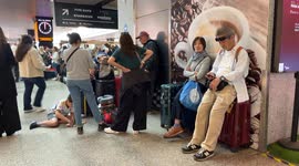 Travelers stopped at the Rome Termini station waiting to be able to catch a train while the boards signal severe delays in train departures and arrivals due to a technical fault at the Termini and Tiburtina railway stations in Rome.