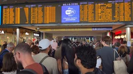 Travelers stopped at the Rome Termini station waiting to be able to catch a train while the boards signal severe delays in train departures and arrivals due to a technical fault at the Termini and Tiburtina railway stations in Rome.