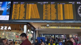 Travelers stopped at the Rome Termini station waiting to be able to catch a train while the boards signal severe delays in train departures and arrivals due to a technical fault at the Termini and Tiburtina railway stations in Rome.