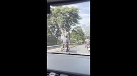 Dangerous Driving: Two Foreigners Arguing While Riding a Motorcycle in Phuket