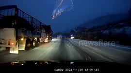 Terrifying moment car skids to stop just inches from overturned truck in icy highway pile-up in China
