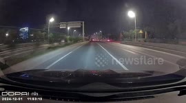 Driver narrowly escapes sinkhole that opened up in middle of road at night