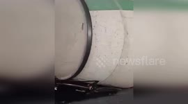 Overturned cement truck flattens car in China