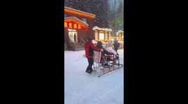 Siberian Huskies pull sleigh at snowy tourist attraction in China