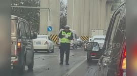 Moment cop nearly slips on icy road to help push cars after snowstorm in China