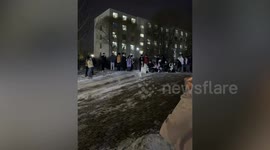 Youngsters make a human train to slide down icy slope
