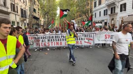 A protester at the head of the procession carries a child on his shoulders while chanting for a free Palestine by making the victory sign with his hands while Palestinian flags are being waved during the protest against the massacre of Palestinians in Gaz