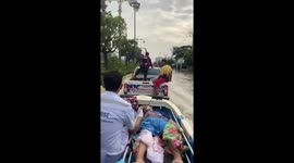Pregnant woman gives birth while being rescued from floods and raced to hospital in a boat
