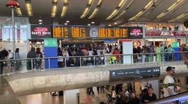 People at Rome's Termini station wait to catch their train as timetables show train cancellations and major delays amid a 24-hour strike called by some independent unions.