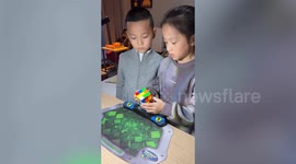 Young duo solve Rubik's Cube together in just 9 seconds