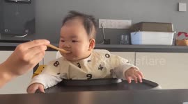 Baby's sour reaction to fruit puree in Liaoning, China