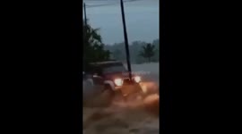 Minibus driven by residents crashes through flash floods in Indonesia