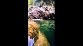 Freediver swims into crystal-clear cave stream