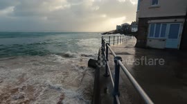 Storm Darragh hits St Ives Cornwall, causing large waves, knocking over bins