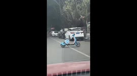 Scooter manoeuvres around road without rider