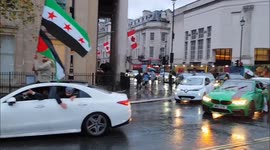 Convoy of Syrians drives past Trafalgar Square in celebration of the fall of the Assad Regime. London, UK 08/12/2024