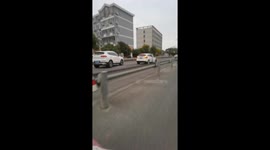 White car missing a tire moving off the road in Jiangsu, China