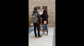 Guy bumps into woman with tray after losing game in Rosario, Santa Fe, Argentina