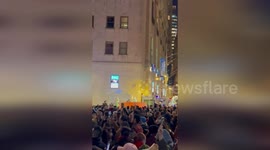 Crowds gather for Wall Street Christmas tree lights switch on
