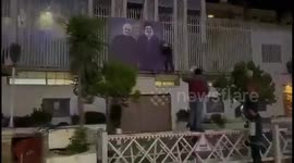 Syria: Syrian rebels tear down Soleimani and Nasrallah poster outside Iran's embassy in Damascus