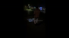 Chinese man amazed by phone projecting videos onto ground