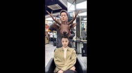 Stylist makes a Christmas reindeer on woman's head in China