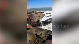 Four strangers join together to save fisherman stuck between rocks and crashing waves