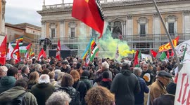 Yellow smoke from a smoke bomb over the heads of protesters in Piazza del Campidoglio under the equestrian statue of Marcus Aurelius and in the background one of the buildings of the Capitoline Museums during the protest against the model imposed on Rome