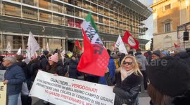 A protester in Piazza del Campidoglio waves an Italian flag with the slogan ‘enough environmental racism’ during a protest against the model imposed on Rome by the Gualtieri administration, organized by various social groups in Rome.