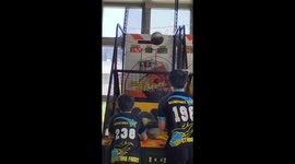 Two boys show perfect shooting skills in arcade game in Taichung, Taiwan
