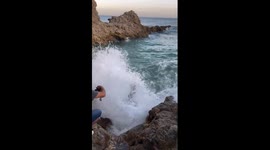 Woman falls into ocean after strong wave hits in Rancho Palos Verdes, California, USA