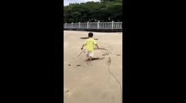 Child falls into hidden sand hole on a beach in Shandong, China