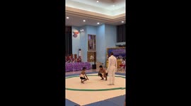 Mind over matter! Skinny boy tries his best up against much larger sumo wrestler