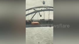 Elderly woman's daring stunt sparks dramatic rescue from bridge by firefighters