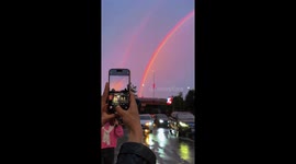 Beautiful double rainbow crowns pink sunset in China