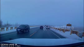 Skilful drivers narrowly escape skidding lorry on icy motorway